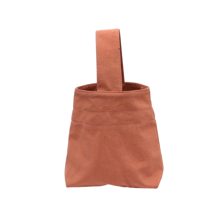 Hvordan er materialet og holdbarheten til håndvesken?